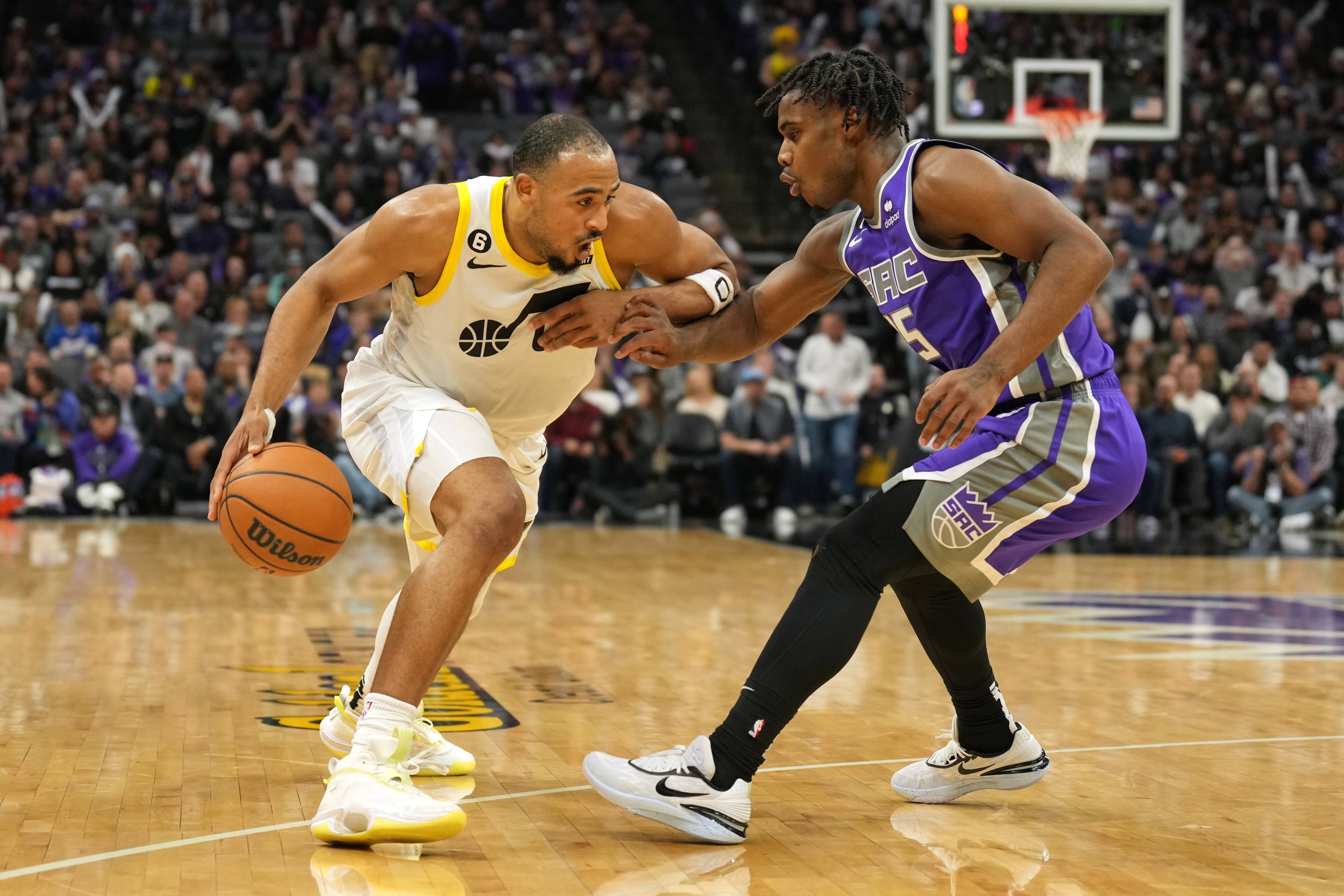Utah Jazz guard Talen Horton-Tucker (left) dribbles against Sacramento Kings guard Davion Mitchell (15) during the fourth quarter at Golden 1 Center.